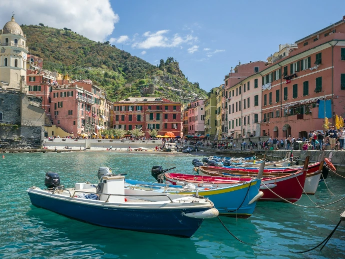 white and blue boat on water near buildings during daytime